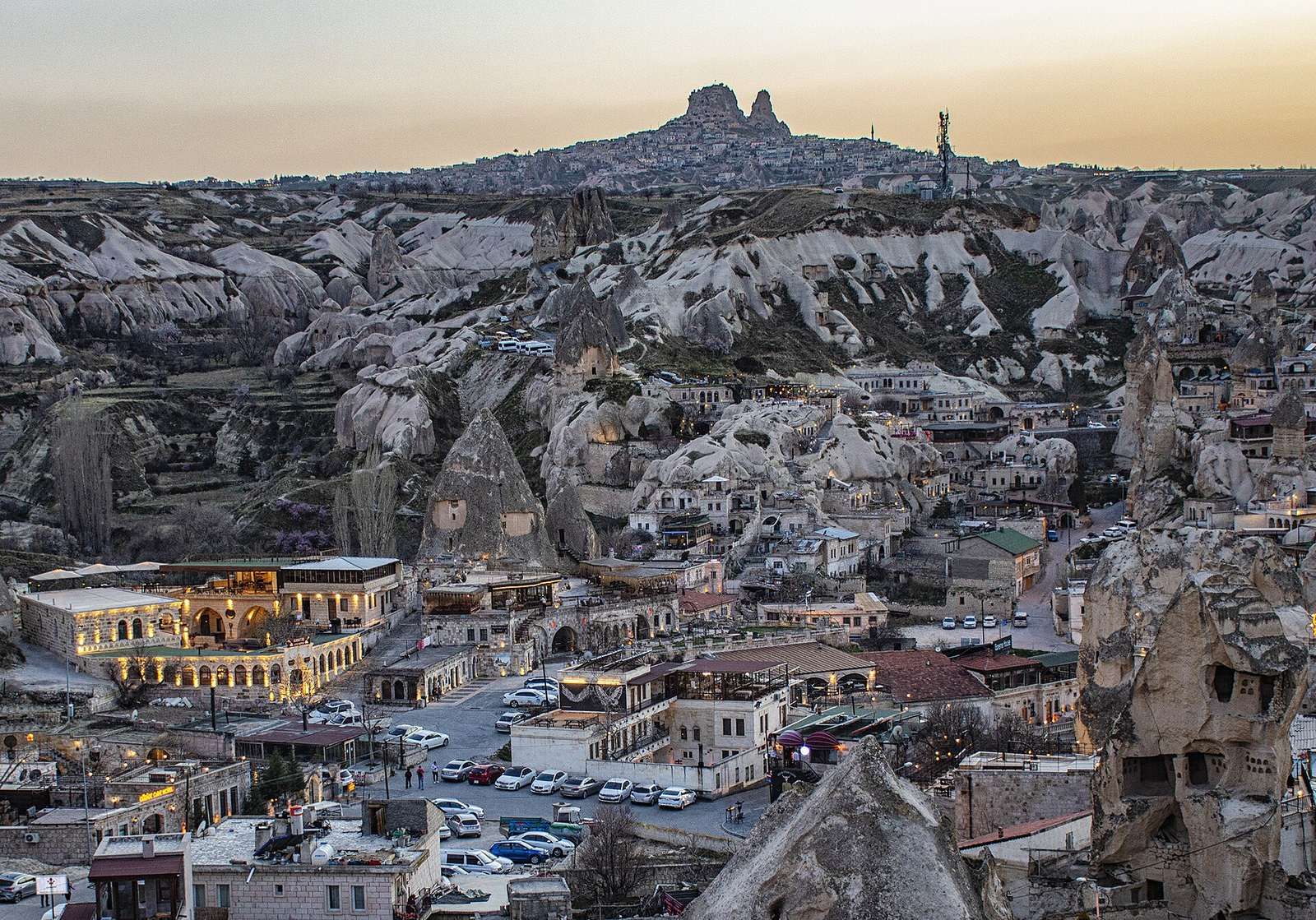 Göreme o zmierzchu z zamkiem Uçhisar na horyzoncie, baza na prywatne wycieczki po Kapadocji